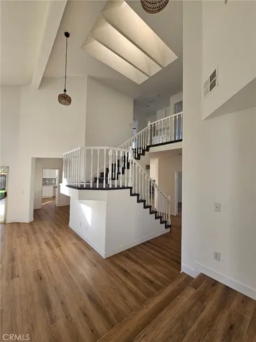 a view of entryway and hall with wooden floor