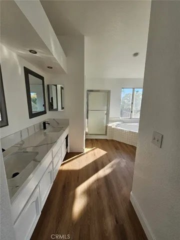 a spacious bedroom with a bed and a sink