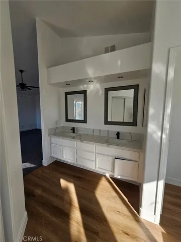 a bathroom with a double vanity sink and mirror