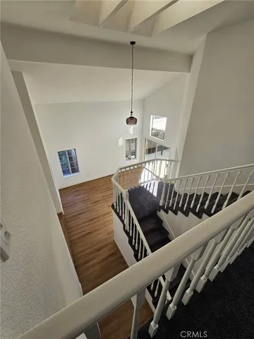 an empty room with windows and fireplace