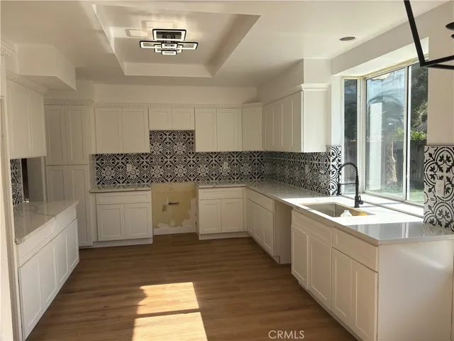 a kitchen with a sink stove and cabinets