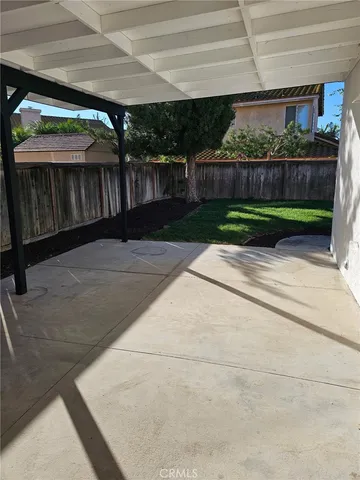 a view of a porch with furniture and garden