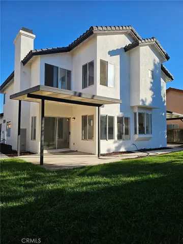 a front view of a house with a garden and pathway