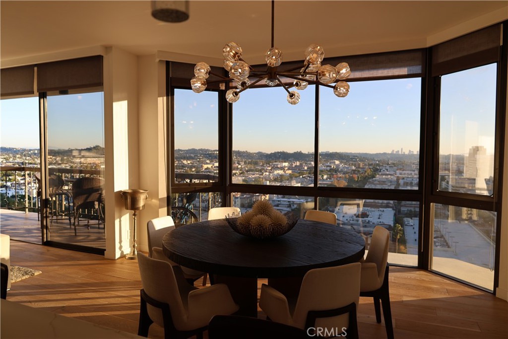 a view of a dining room with furniture window and wooden floor