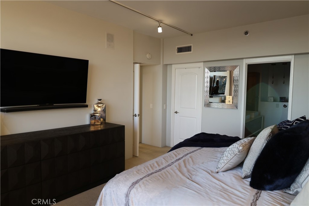 222 Monterey Road, Unit 1603 Glendale, CA 91206 - Photo 19 of 38 a bedroom with a bed and a flat screen tv