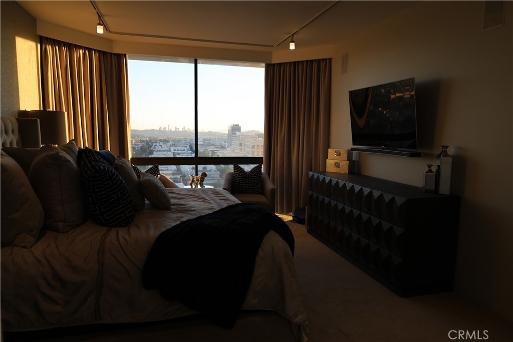 222 Monterey Road, Unit 1603 Glendale, CA 91206 - Photo 20 of 38 a living room with a bed furniture and a flat screen tv