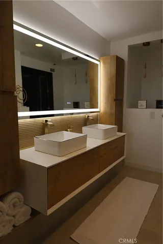 a bathroom with a tub sink and mirror