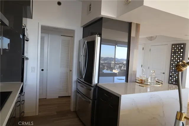 a kitchen with stainless steel appliances kitchen island granite countertop a refrigerator and a stove