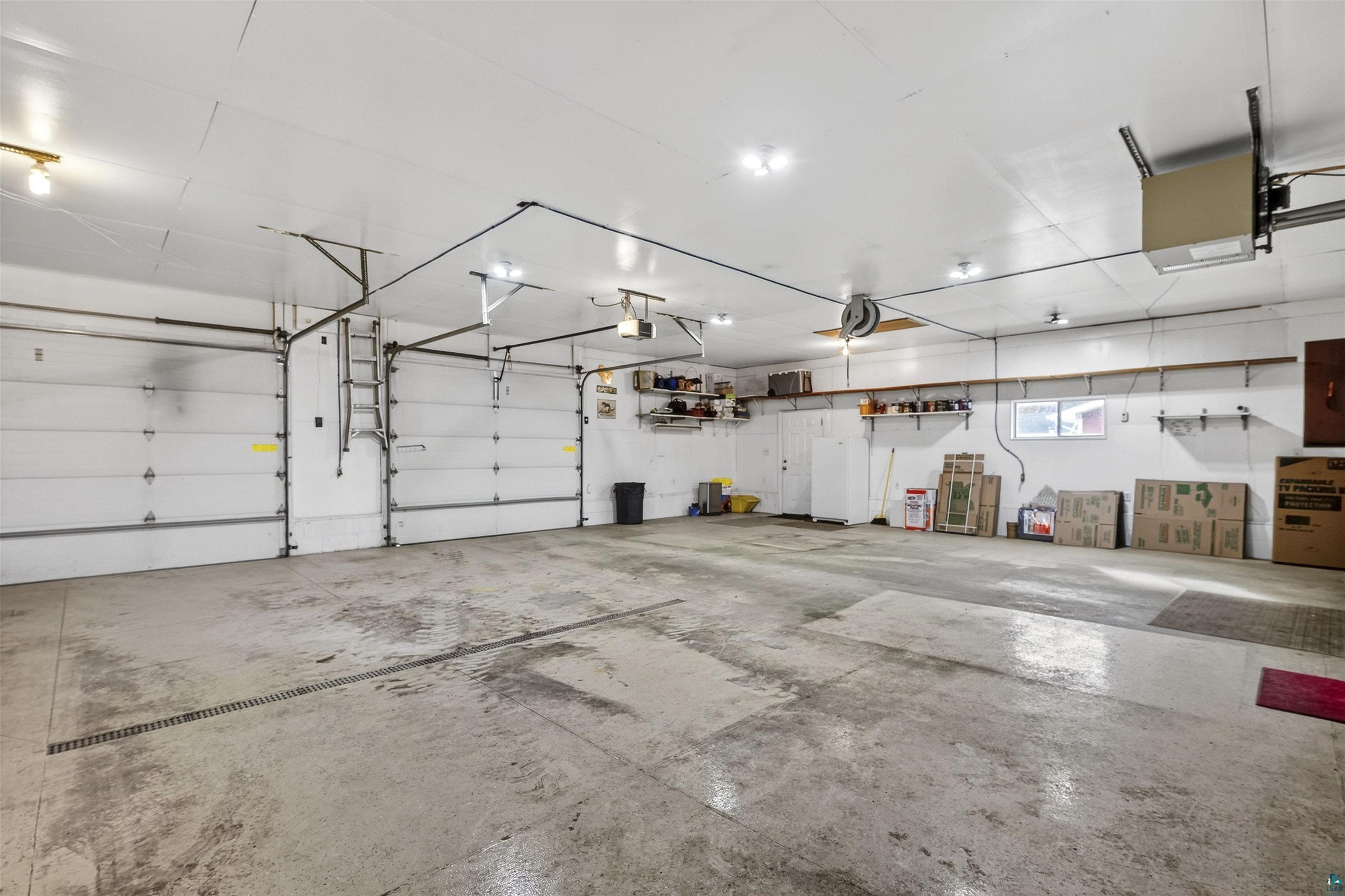 11702 East Mail Road Gordon, WI 54838 - Photo 12 of 43 Garage with white refrigerator and a heating unit