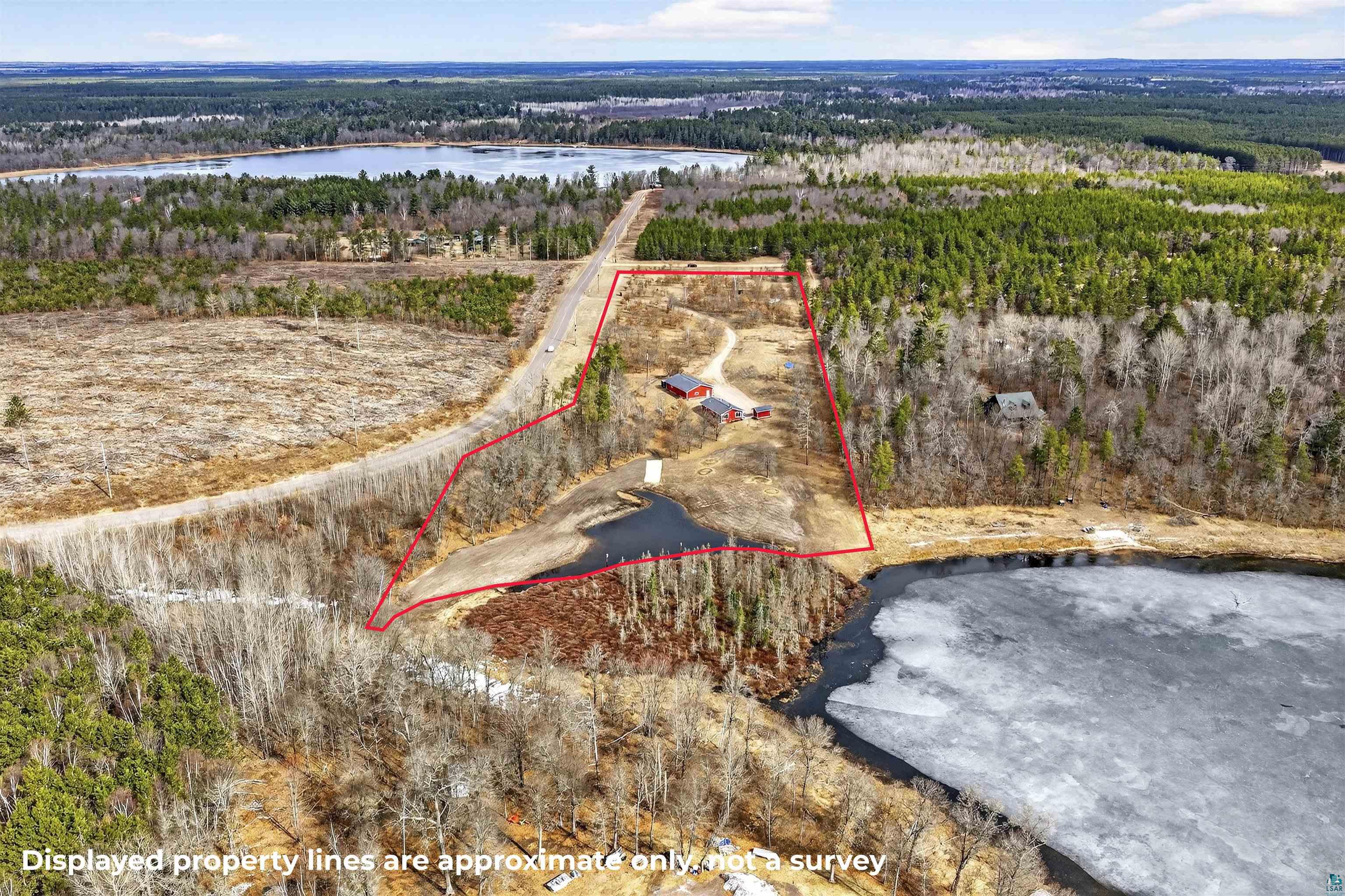 11702 East Mail Road Gordon, WI 54838 - Photo 2 of 43 Aerial view of property's location with property parcel outlined and a large body of water