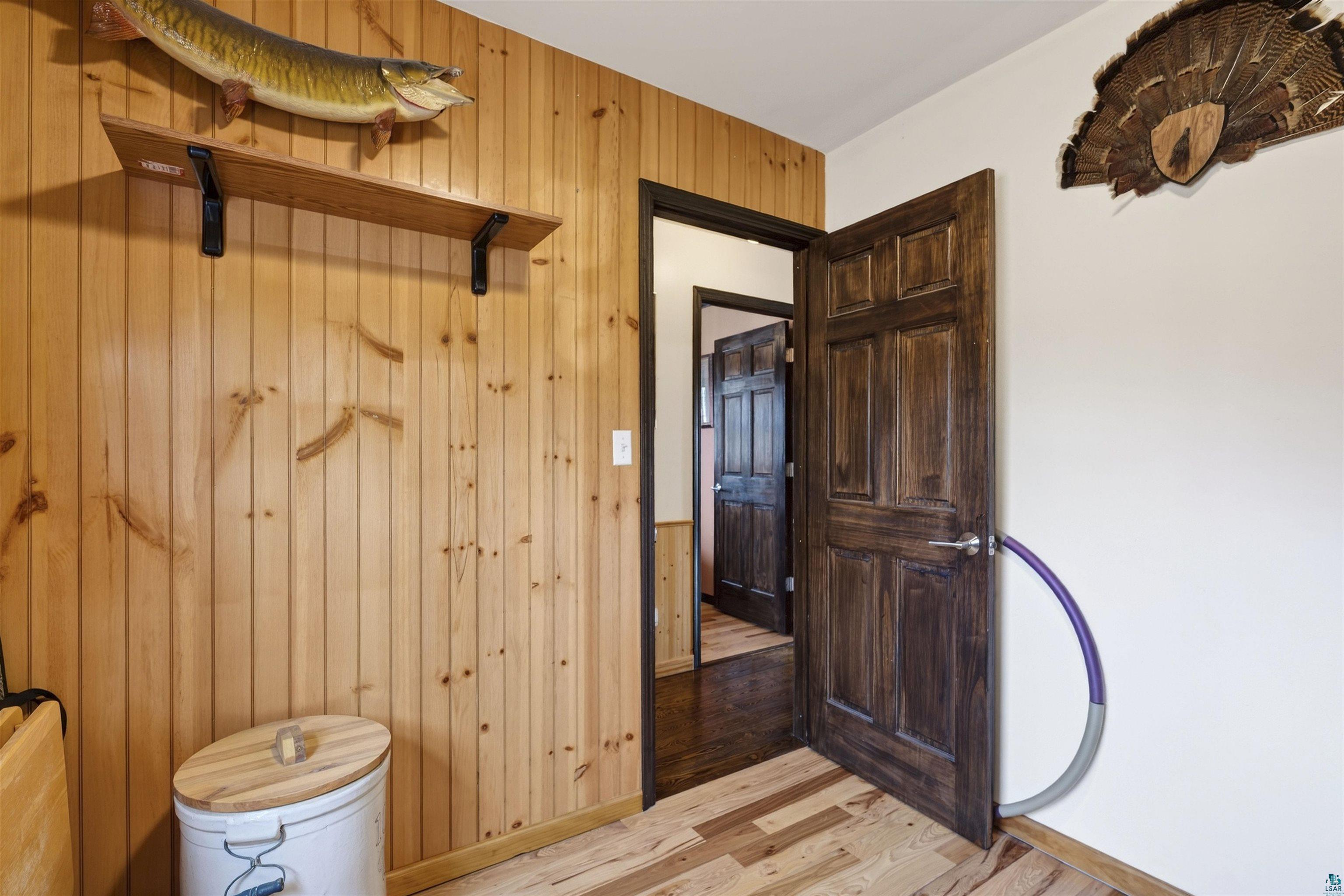 11702 East Mail Road Gordon, WI 54838 - Photo 43 of 43 Half bath featuring wood walls and light wood-style flooring