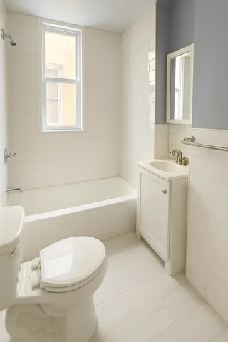 a bathroom with a toilet a sink and bathtub