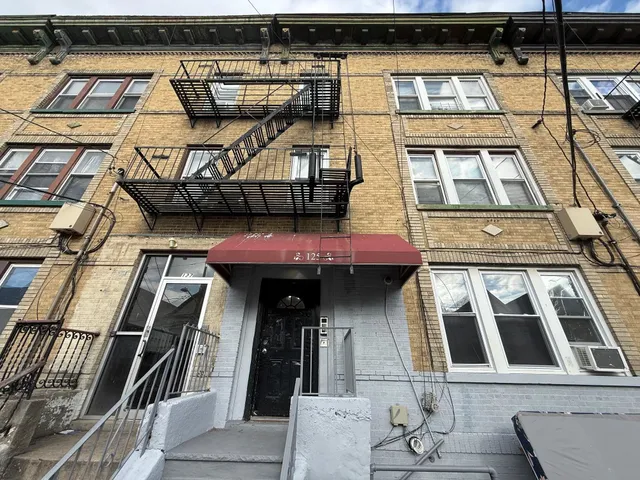a view of a brick house with many windows