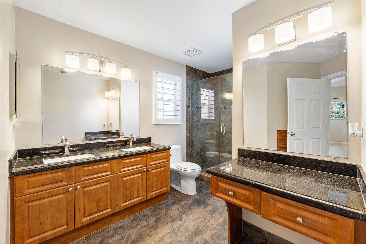 17270 Boca Club Boulevard, Unit 1707 Boca Raton, FL 33487 - Photo 22 of 68 a spacious bathroom with a granite countertop double vanity and a mirror