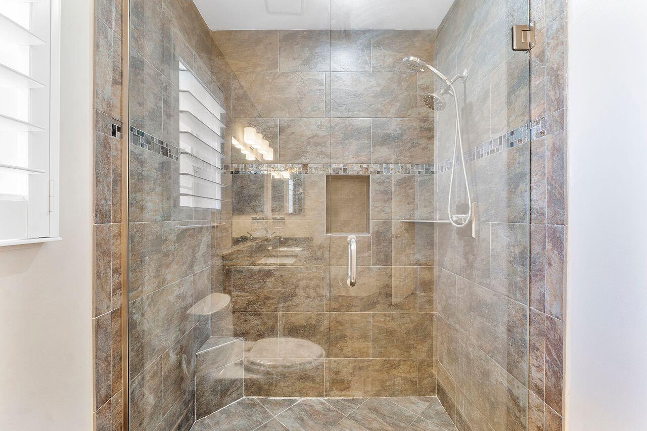 17270 Boca Club Boulevard, Unit 1707 Boca Raton, FL 33487 - Photo 23 of 68 a bathroom with a shower