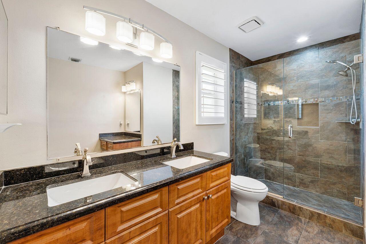 17270 Boca Club Boulevard, Unit 1707 Boca Raton, FL 33487 - Photo 25 of 68 a bath room with a sink and a mirror