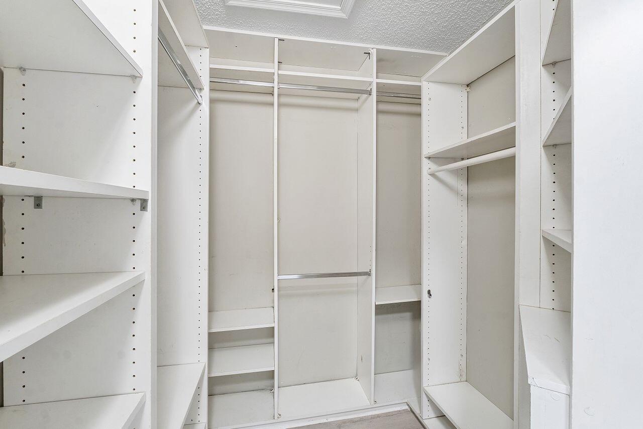 17270 Boca Club Boulevard, Unit 1707 Boca Raton, FL 33487 - Photo 27 of 68 a view of walk in closet with empty racks