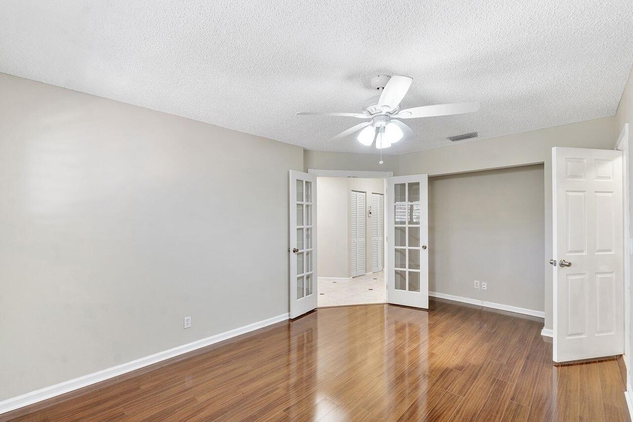 17270 Boca Club Boulevard, Unit 1707 Boca Raton, FL 33487 - Photo 29 of 68 an empty room with wooden floor and ceiling fan