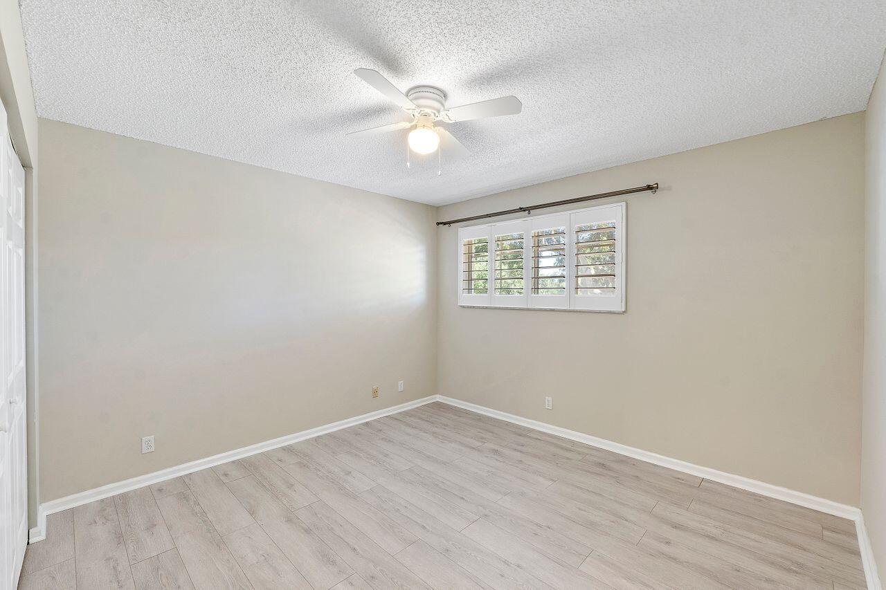 17270 Boca Club Boulevard, Unit 1707 Boca Raton, FL 33487 - Photo 33 of 68 wooden floor in an empty room with a window