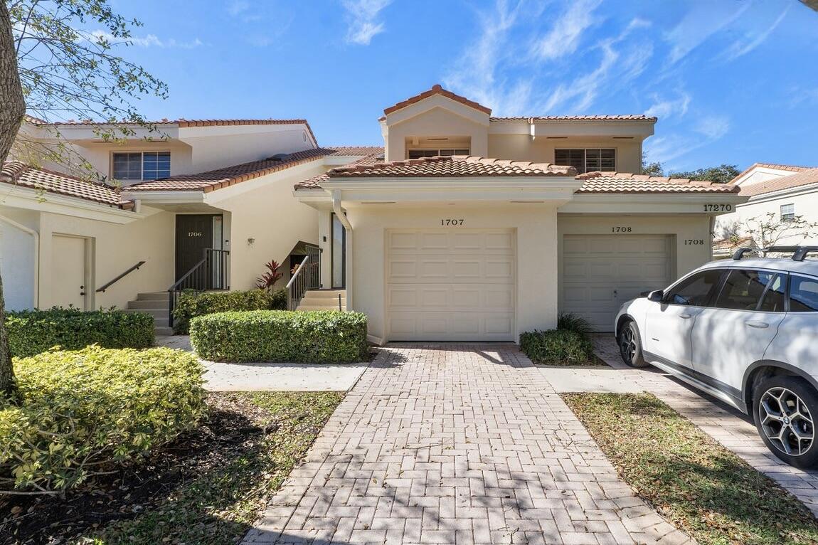 17270 Boca Club Boulevard, Unit 1707 Boca Raton, FL 33487 - Photo 60 of 68 a front view of a house with a yard