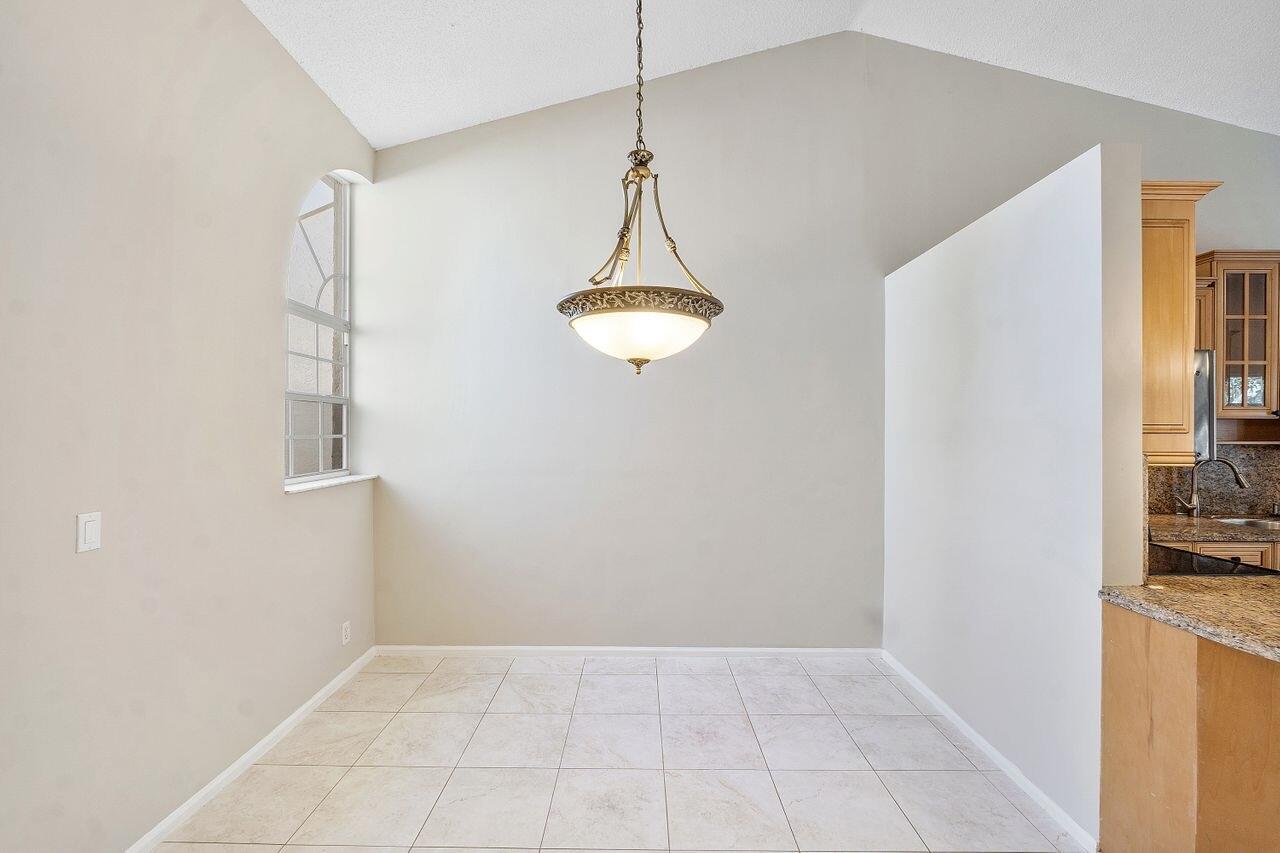 17270 Boca Club Boulevard, Unit 1707 Boca Raton, FL 33487 - Photo 10 of 68 a room with a chandelier and a window
