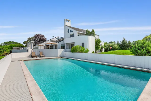 a swimming pool view with a garden space