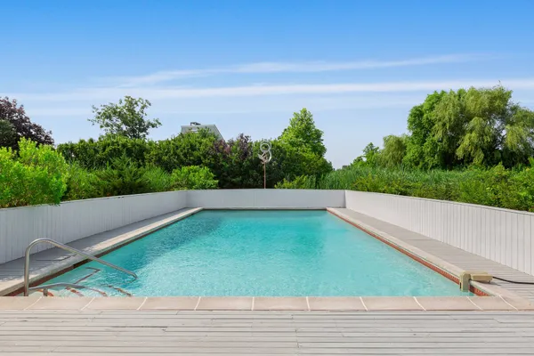 a view of a swimming pool with a yard