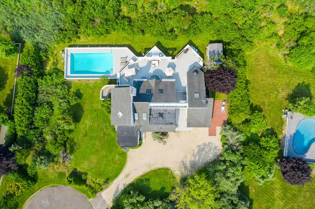 an aerial view of a house with garden space and street view