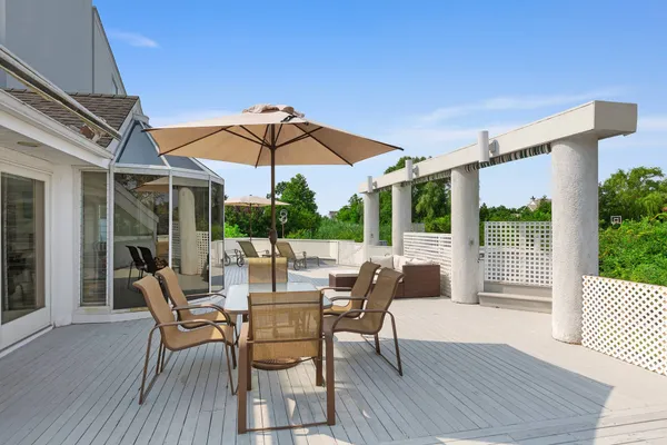 a view of a patio with a table and chairs under an umbrella