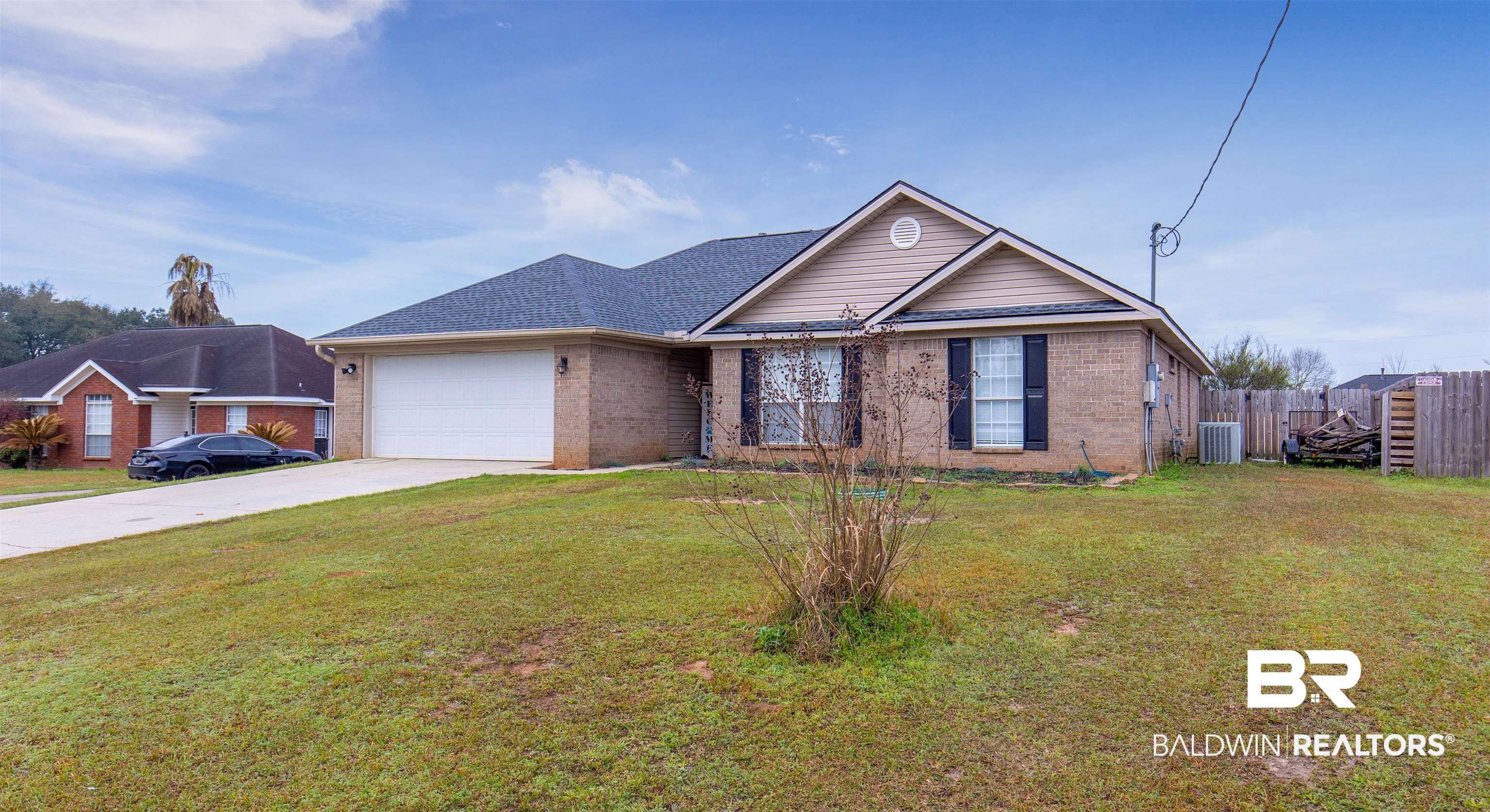 4950 Clealand Court Mobile, AL 36695 - Photo 2 of 20 Ranch-style home featuring a garage, concrete driveway, brick siding, and fence