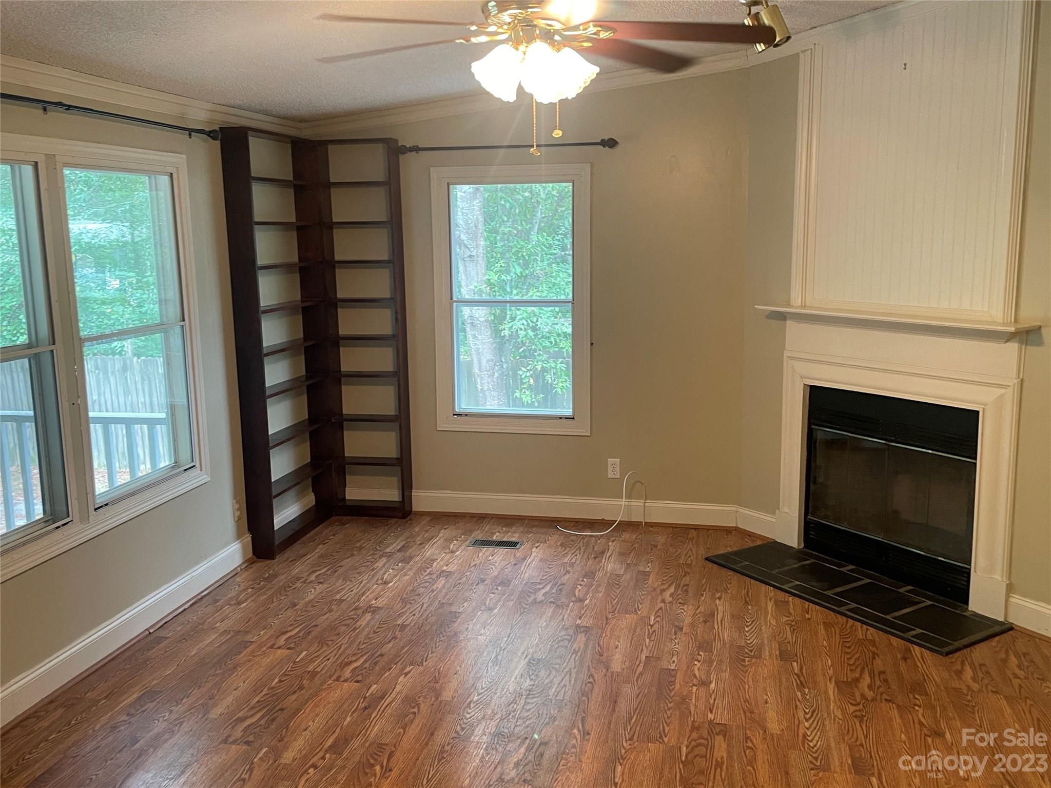 3850 Winter Road Rock Hill, SC 29730 - Photo 9 of 20 a view of an empty room with wooden floor fireplace and a window