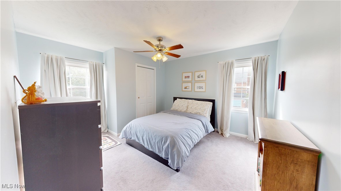 2412 Charney Road Cleveland, OH 44118 - Photo 25 of 48 Carpeted bedroom with ceiling fan, a closet, and multiple windows