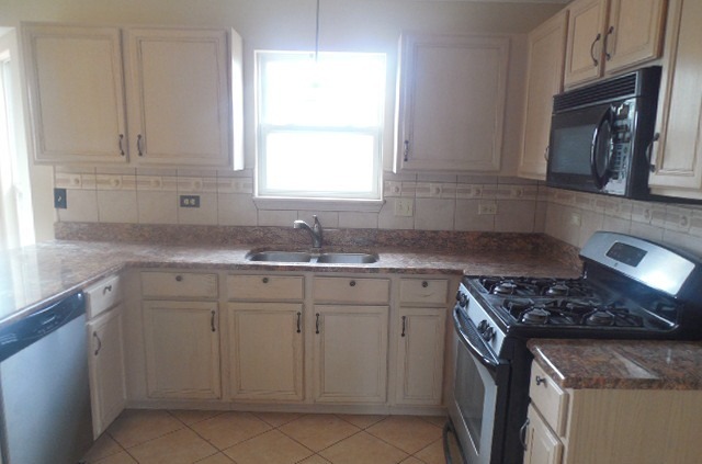 152 Sedgewicke Drive Romeoville, IL 60446 - Photo 5 of 16 a kitchen with cabinets appliances a sink and a window