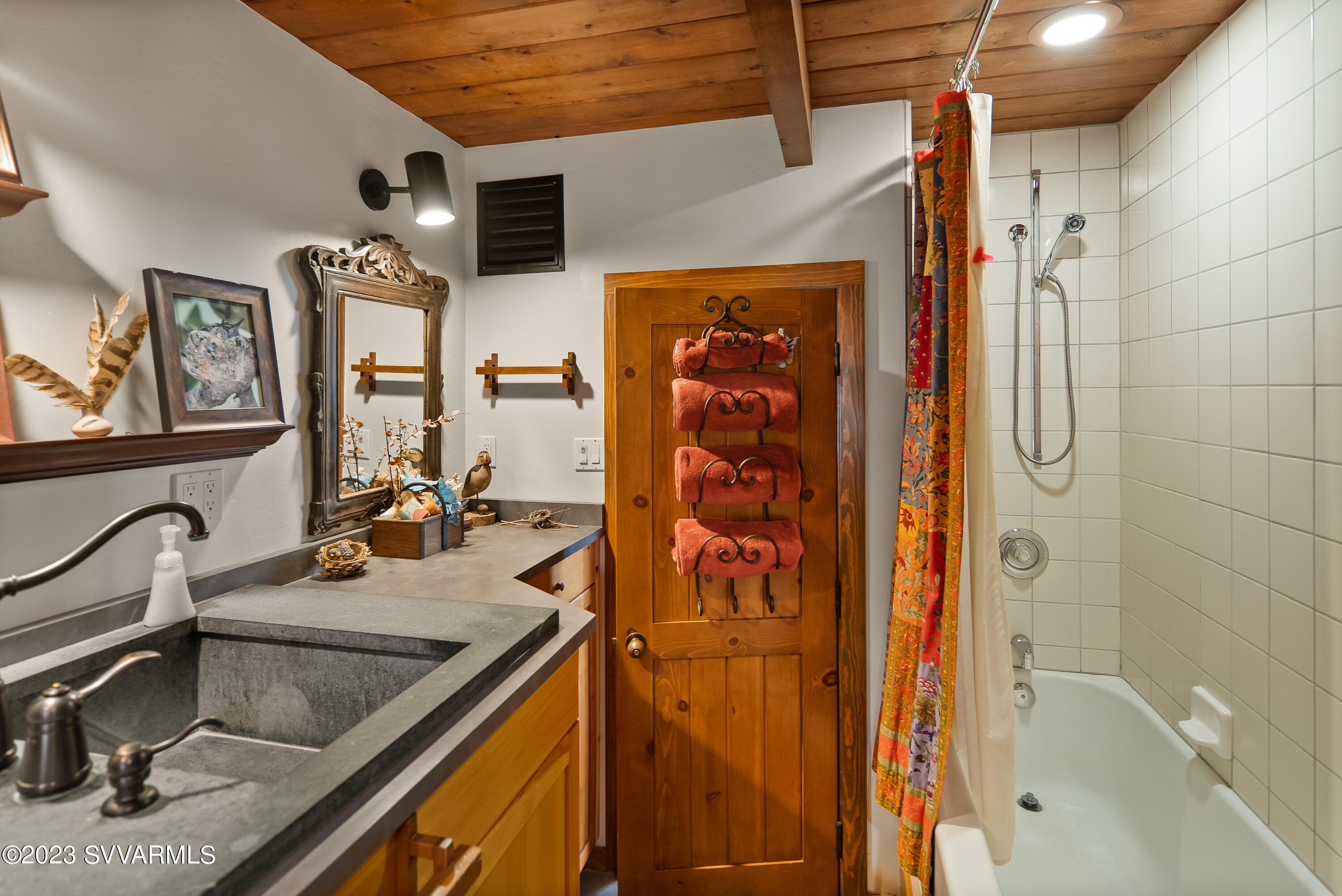 45 Copper Cliffs Lane Sedona, AZ 86336 - Photo 20 of 39 a bathroom with a granite countertop sink a mirror and shower