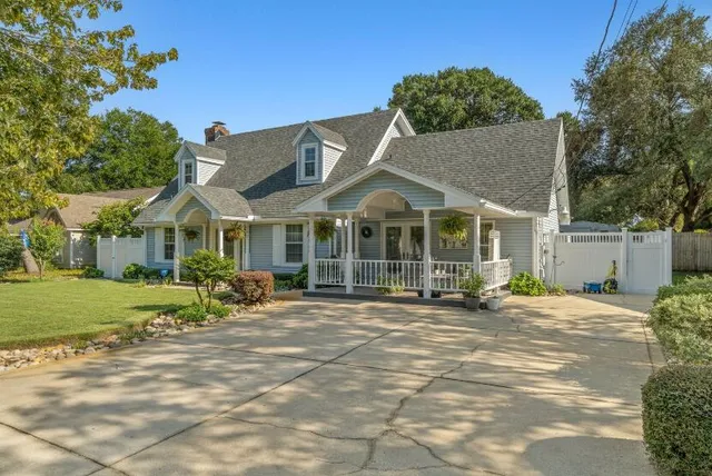 a view of a house with a yard and sitting area