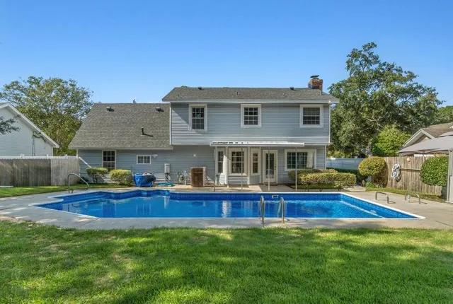 a view of house with outdoor space and swimming pool