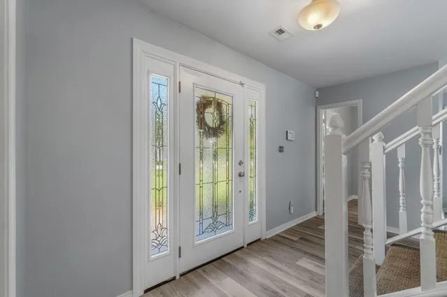 a view of an entryway with wooden floor