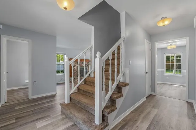a view of entryway with stairs and wooden floor
