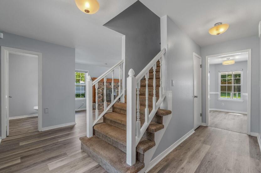 14 Winfield Way Mary Esther, FL 32569 - Photo 10 of 46 a view of entryway with stairs and wooden floor
