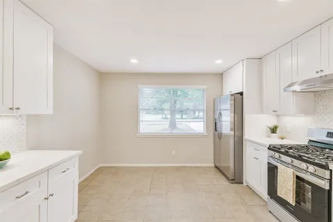 a kitchen with a stove a sink and a refrigerator