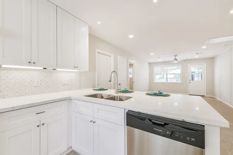 a kitchen with a sink and cabinets