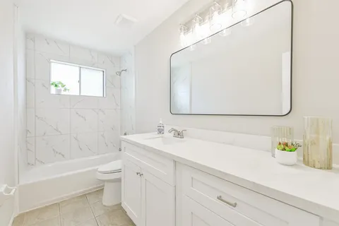 a bathroom with a sink a toilet and a bathtub