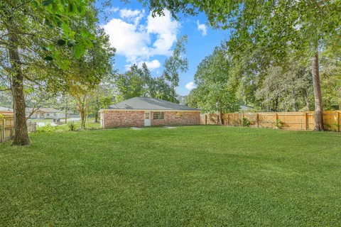 a view of garden with trees in the background