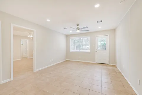 an empty room with windows and closet