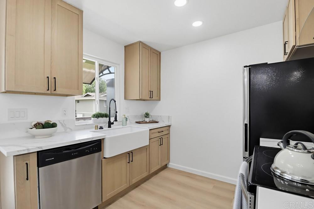 895 Jamacha Road El Cajon, CA 92019 - Photo 15 of 33 a kitchen with a sink a stove and cabinets