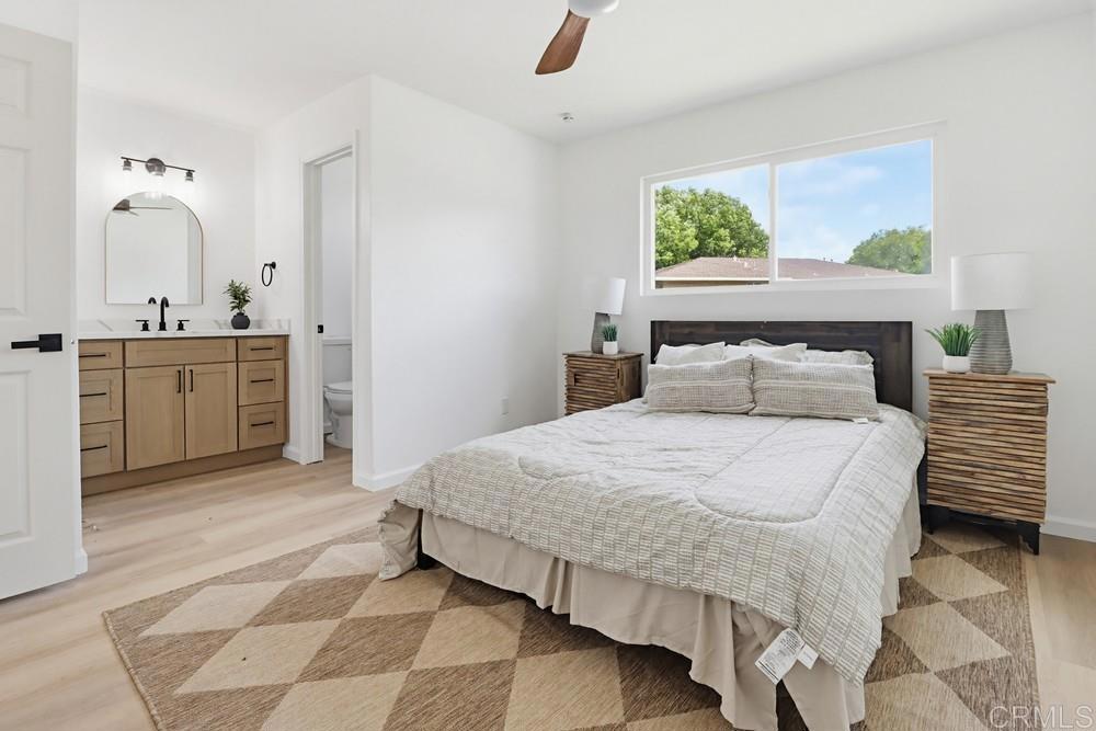 895 Jamacha Road El Cajon, CA 92019 - Photo 18 of 33 a bedroom with a bed and a chandelier