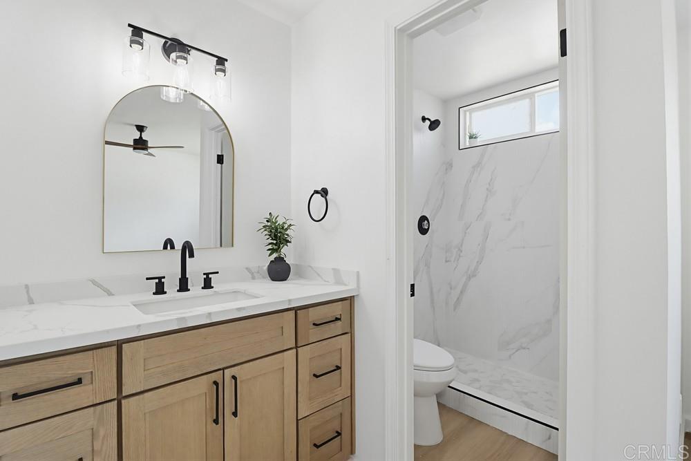 895 Jamacha Road El Cajon, CA 92019 - Photo 20 of 33 a bathroom with a granite countertop sink a toilet and shower