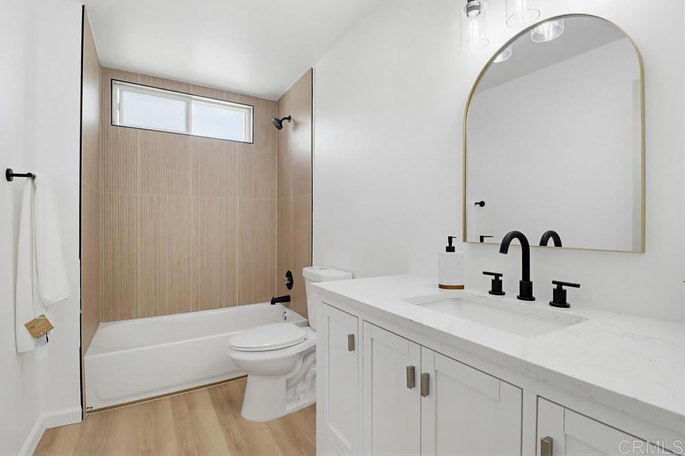 895 Jamacha Road El Cajon, CA 92019 - Photo 24 of 33 a bathroom with a sink a toilet and a large mirror