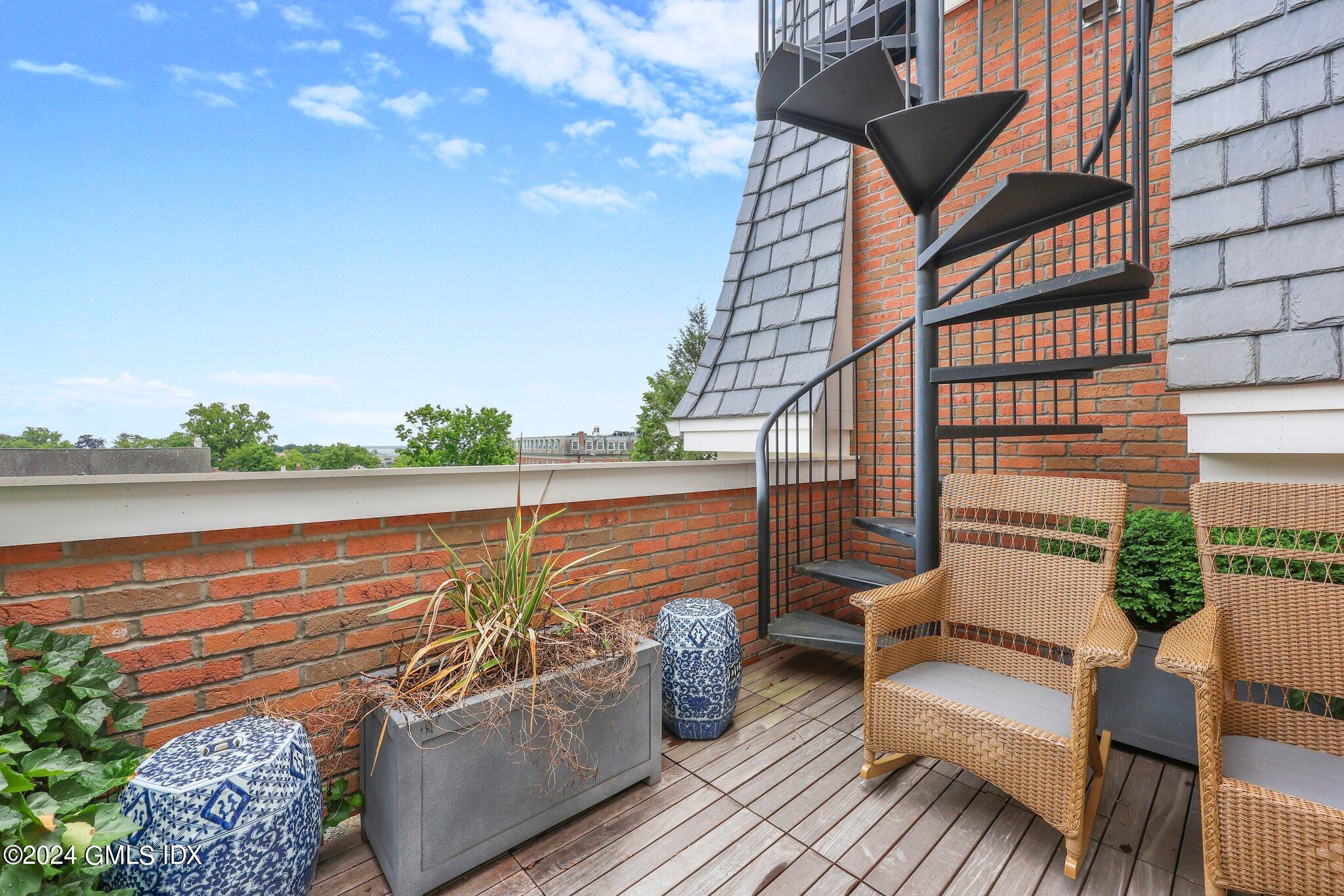 62 Mason Street, Unit PHW Greenwich, CT 06830 - Photo 12 of 18 a balcony with outdoor seating and water view