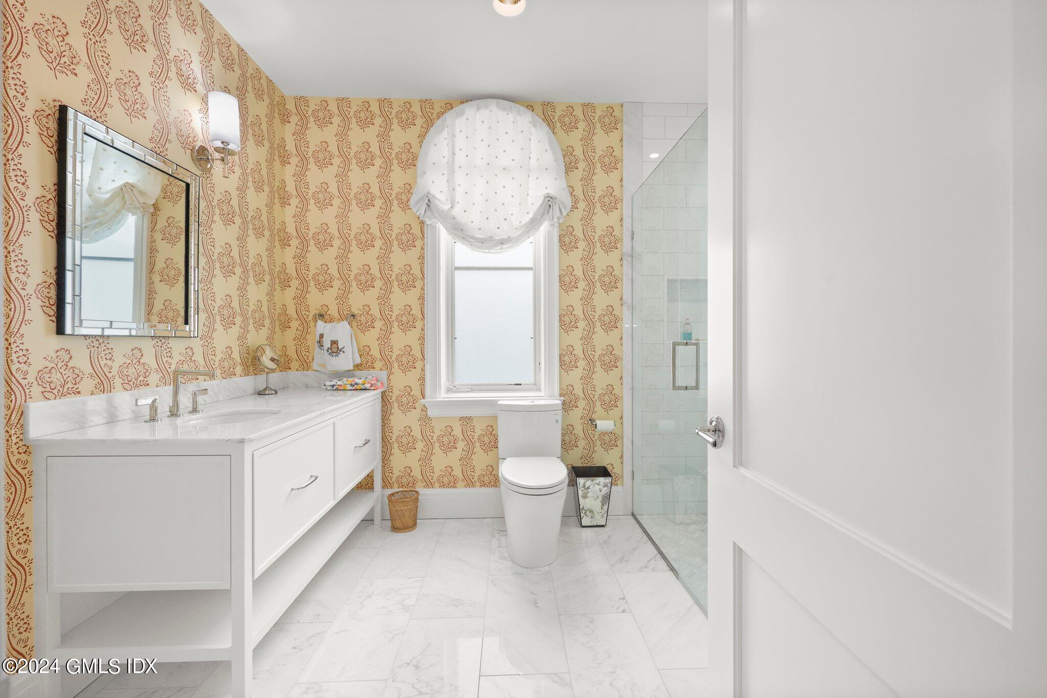 62 Mason Street, Unit PHW Greenwich, CT 06830 - Photo 16 of 18 a bathroom with a double vanity sink mirror and a toilet
